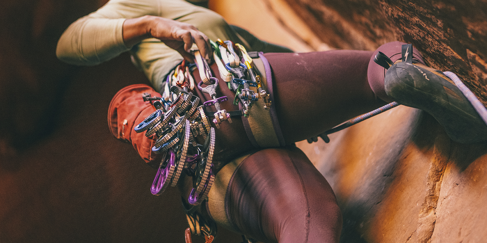 Climber with gear on a rockface 